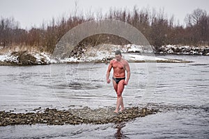 Man walrus after winter swimming in ice cold river water