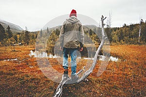 Man wanderer standing alone in swamp forest