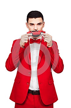 Man wants to buy a car. bearded man in a red suit and red toy car on a white background