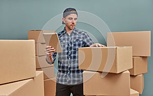 Man in warehouse with cardboard boxes