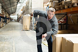 Man warehouse worker carrying boxes