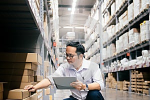 Man warehouse worker checking goods at warehouse.