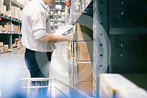 Man warehouse worker checking goods at warehouse.