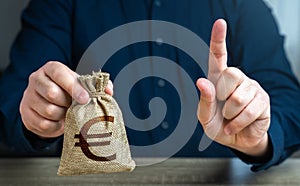 A man warns with his finger offering a euro money bag. Bad credit history.