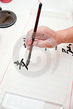 A man was writing Chinese calligraphy