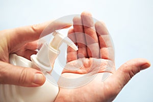 Man wash his hands with liquid soap.