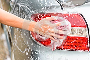 The man wash the Taillight of car