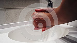 A man washes his hands at home close-up. Clean hands protect against infection. Hygiene and health. Stop coronavirus. Bathroom sin