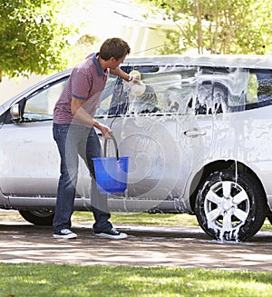 Man Washing Car In Drive