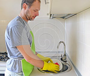 Man washing dish in the kitchen
