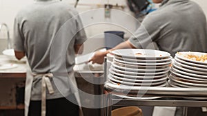 Man washing dish in sink