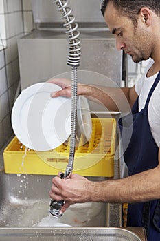 Man washing dishes photo