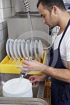 Man washing dishes photo