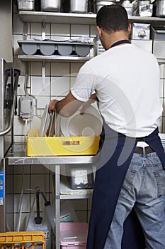 Man washing dishes photo