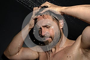 Man washing hair in bath. Guy bathing shower head in bathtub. Face in foam in shower. Bathing man taking shower. Close