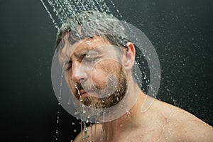 Man washing hair in bath. Guy bathing shower head in bathtub. Face in foam in shower. Bathing man taking shower. Close