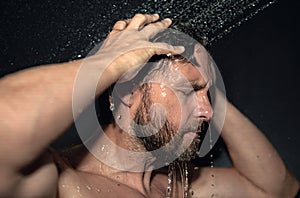 Man washing hair, close up portrait. Man bathing shower washing hair head in bathroom. Male model washing hair in shower
