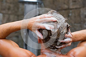 Man washing hair with shampoo photo