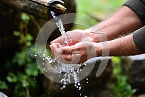 Man washing hands in fresh, cold, potable water