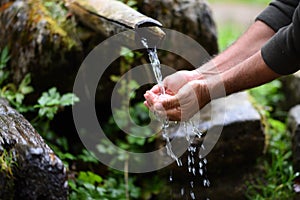 Man washing hands in fresh, cold, potable water