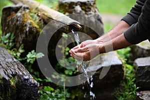 Man washing hands in fresh, cold, potable water