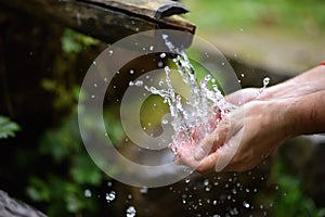 Man washing hands in fresh, cold, potable water