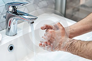 Man is washing hands with soap. Coronavirus pandemic. Covid-19