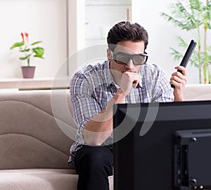 Man watching 3d tv at home