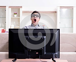 Man watching 3d tv at home