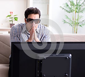 Man watching 3d tv at home