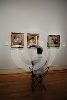 Man watching on the art picture at museum