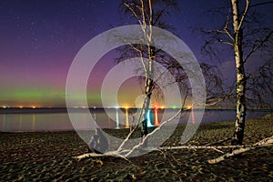 Man watching aurora over the Baltic Sea in Gdansk, Poland