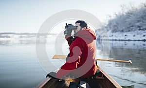 Man watching birds from a canoe