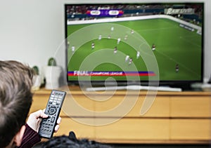 Man watching a football game on TV