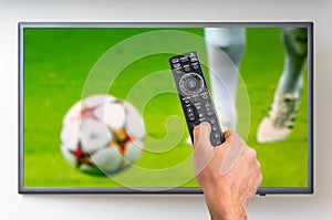 Man is watching football match on TV