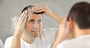 Man watching his hair loss