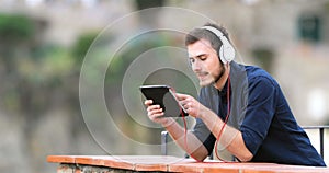 Man watching and listening media on a tablet