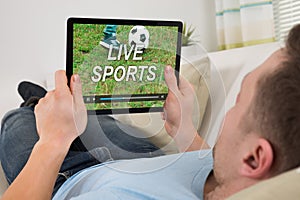 Man Watching Live Sports On Digital Tablet