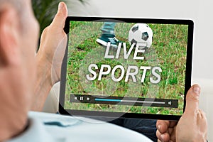 Man Watching Live Sports On Digital Tablet