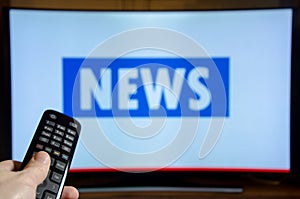 Man watching News on TV and using remote controller