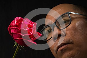 Man watching on a red rose black background