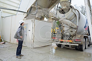 Man watching refill cement mixer