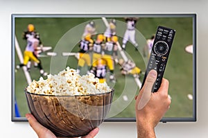 Man is watching rugby match on TV