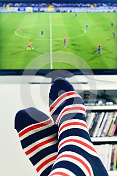 Man watching a soccer match in the TV