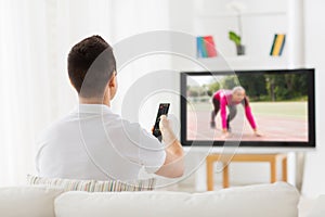 Man watching sport channel on tv at home