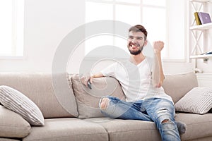 Man watching sports on tv and supporting team