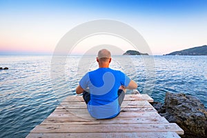 Man watching sunset over ionian sea