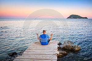 Man watching sunset over ionian sea