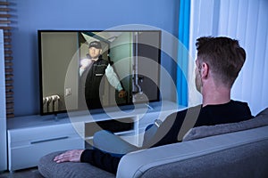 Man Watching Suspense Movie On Television photo