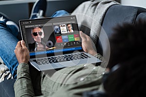 Man Watching Thriller Movie On Laptop photo